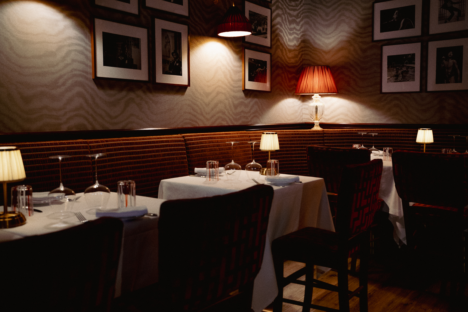 The Dal Salumiere dining room set and lit by table lamps