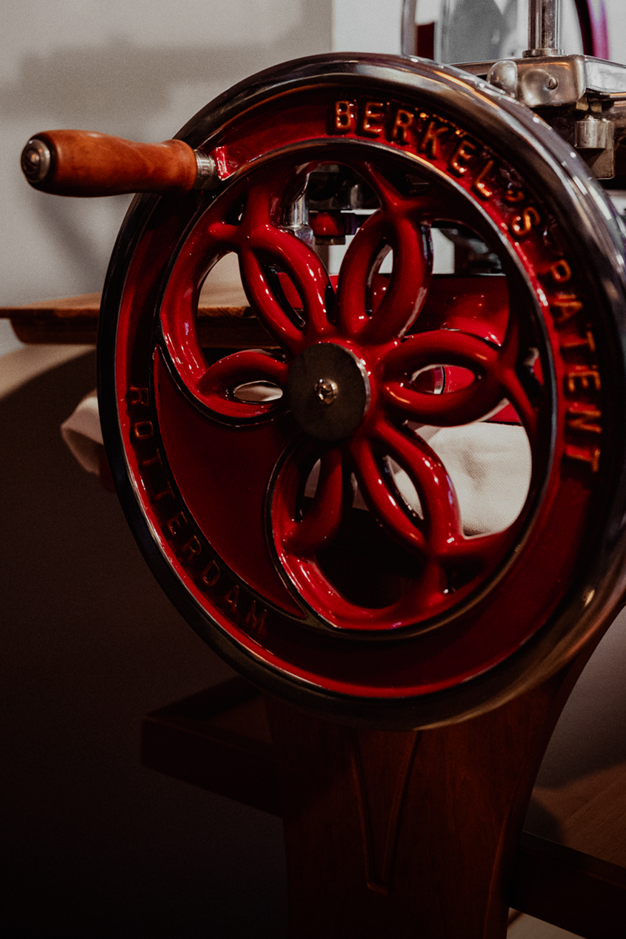 Close-up of the red flywheel on a historic Berkel meat slicer
